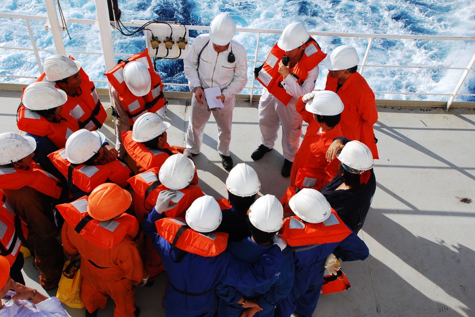Crew in safety gear during a briefing on deck